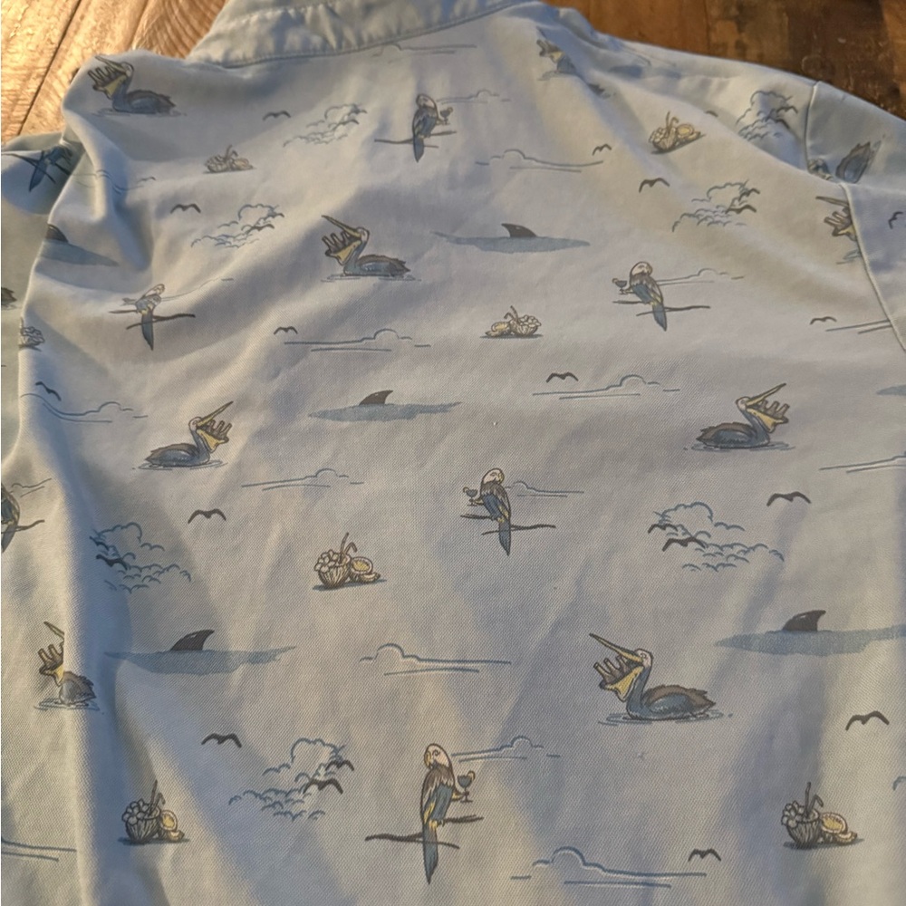 Travis Mathew Sky Blue Shirt with Pelican and Shark Design